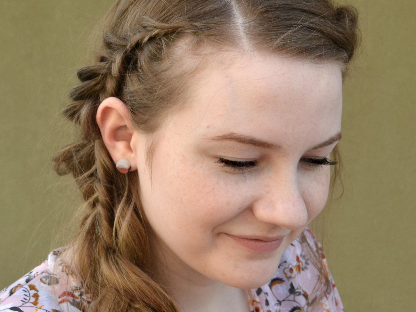 model wearing natural purpleheart wood earrings with white epoxy accent