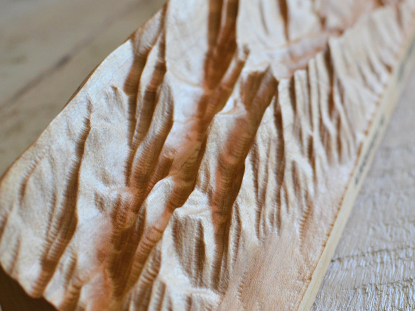 realistic wood sculpture of sandia mountains