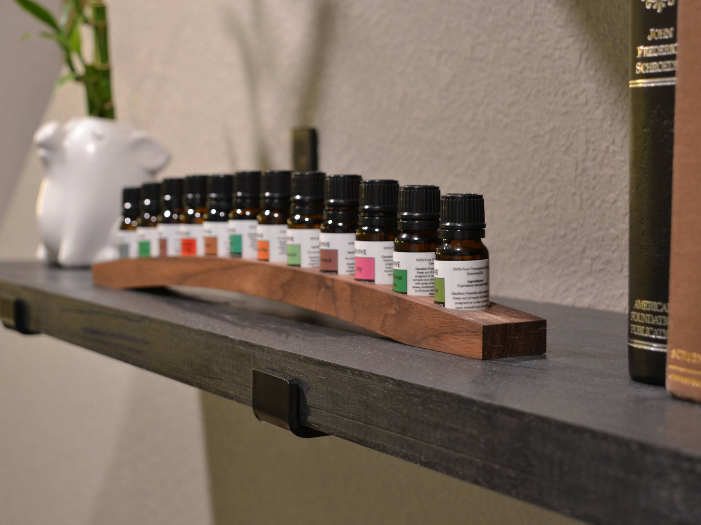 revive oils in modern arched walnut wood holder