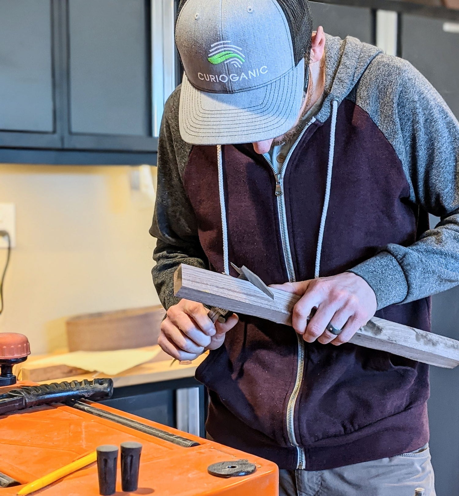 woodworker measuring walnut wood with calipers