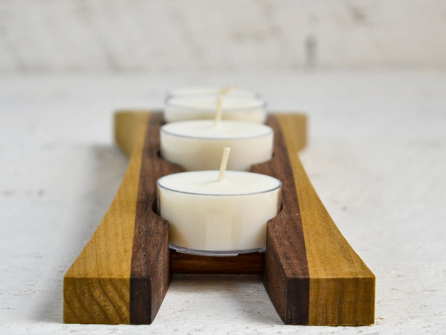 white tea candles in decorative stand