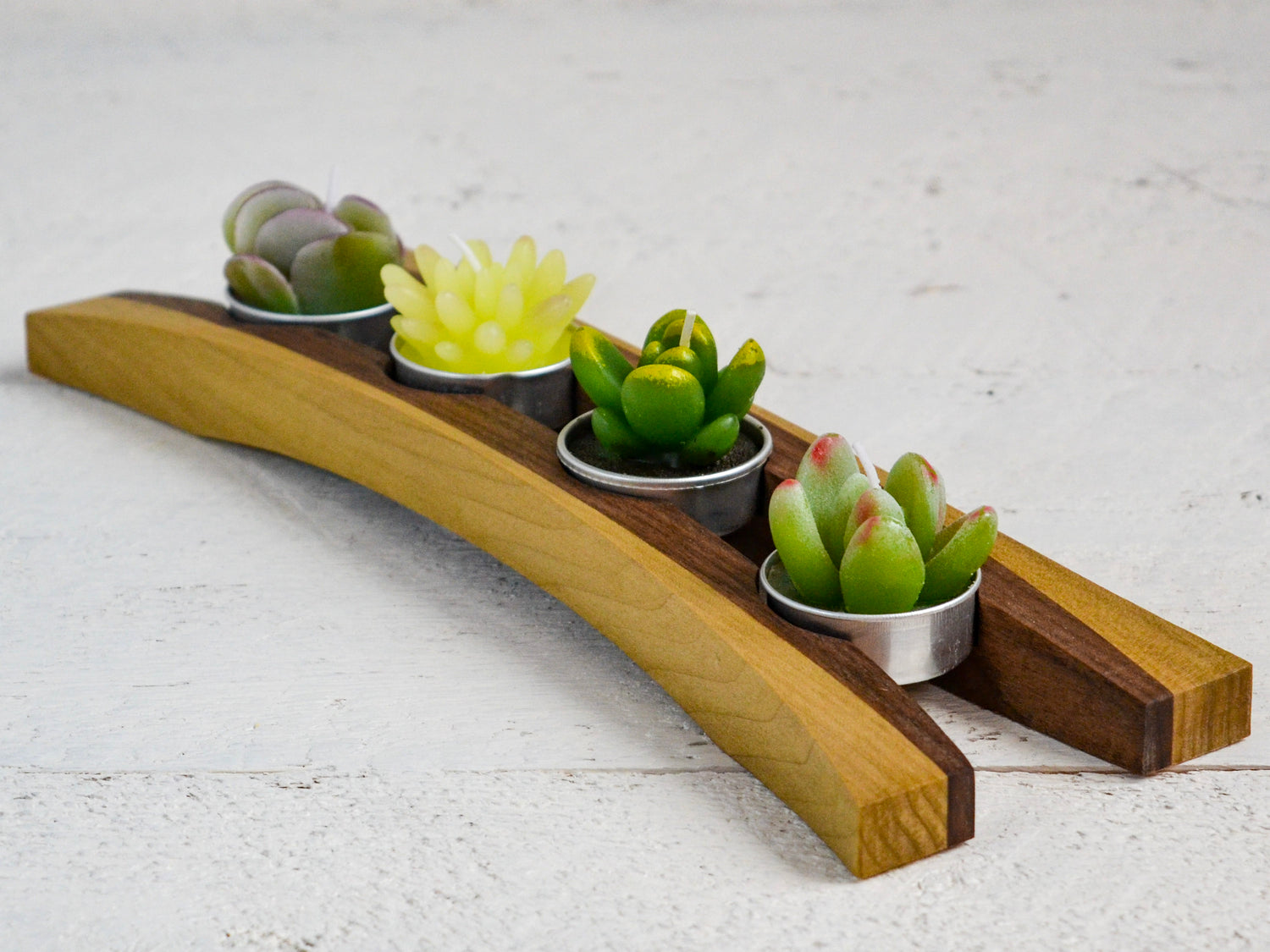 green succulent tea candles in wooden cradle