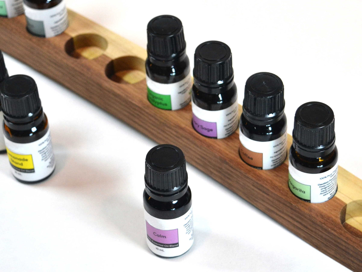 essential oil bottles with handcrafted wooden holder