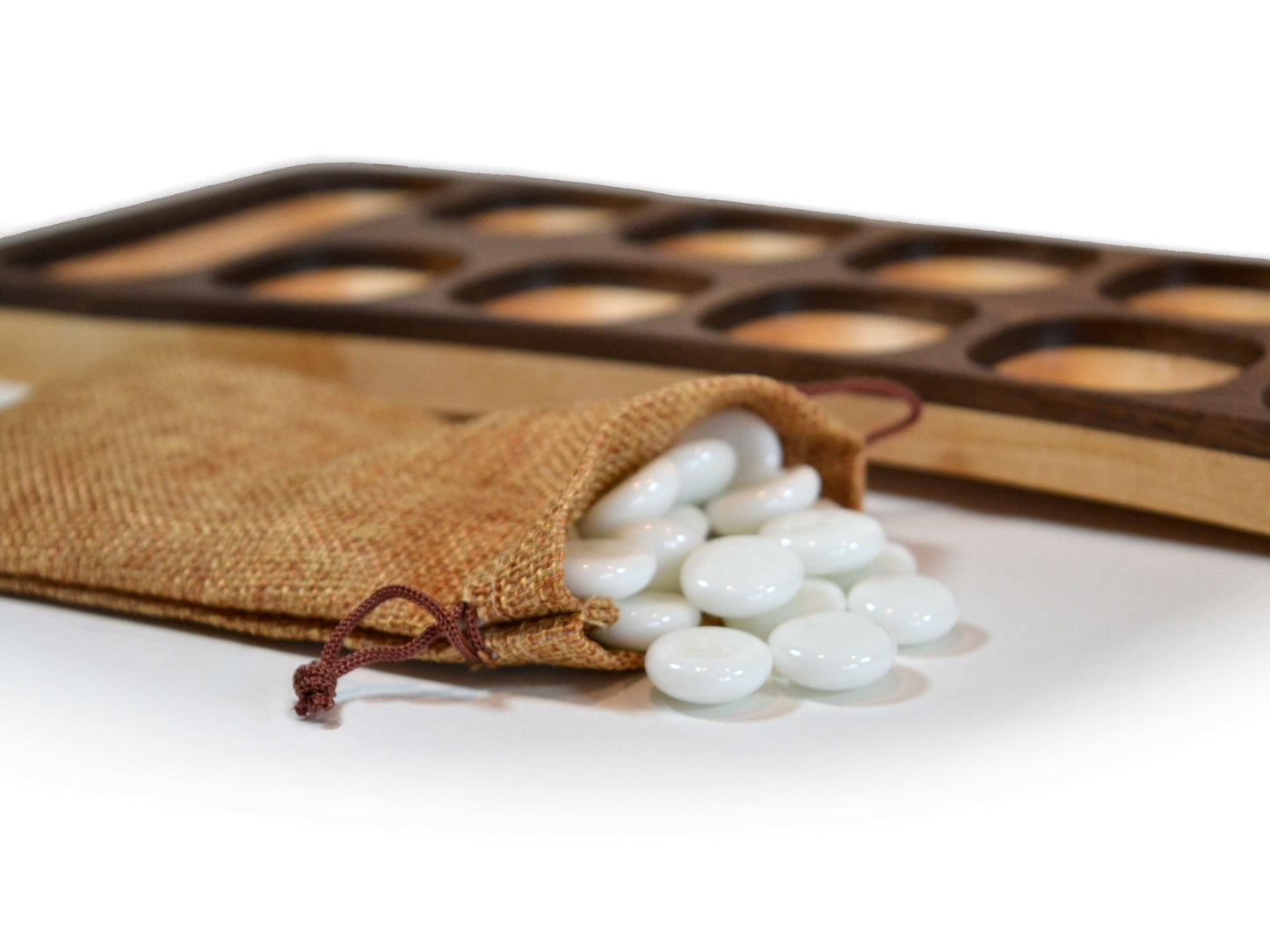 white mancala beads with wooden board