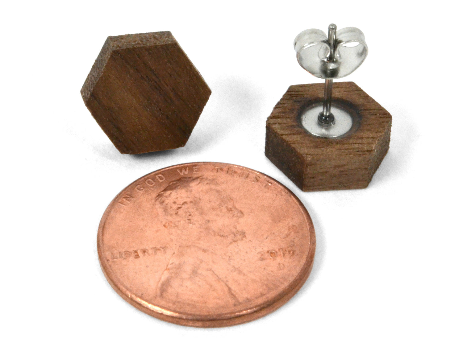 small wooden earrings, hexagon studs with penny for scale