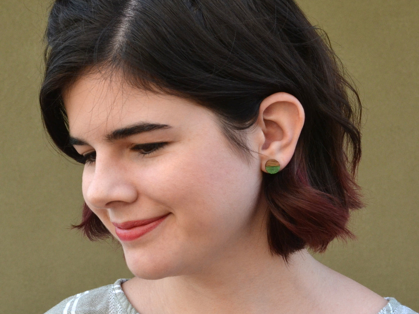 girl wearing two tone forest green and black walnut earring studs
