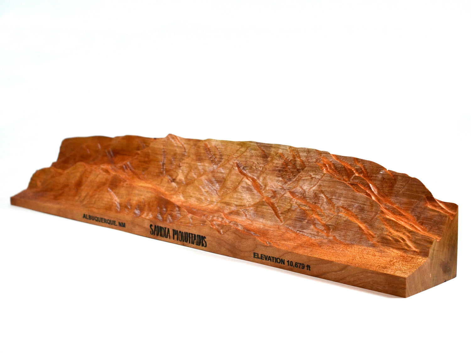 red cherry wood sandia mountains topographical carving